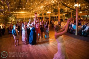 Bride throwing flower bouquet at the people