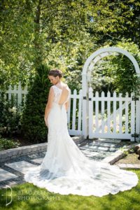 Bride posing for picture in the garden