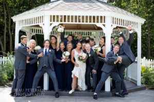 Bride and groom posing with the guests