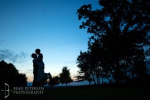 Dark view of groom lifting the bride