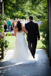 A bride and groom walking down the aisle.