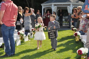 Boy and a girl walking between the people