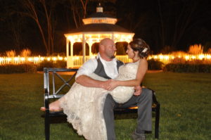 Bride sitting on the groom posing