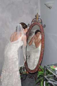 Bride getting ready looking in to the mirror