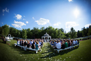 A wedding ceremony in a grassy field.