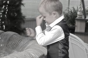 A child in black and whit outfit holding eyes