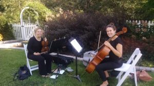 Women playing music with violin at wedding