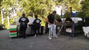 Group of men in same outfit cooking