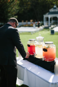 A man in black suit getting a drink