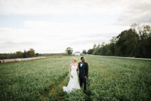 Bride and groom posing in the garden