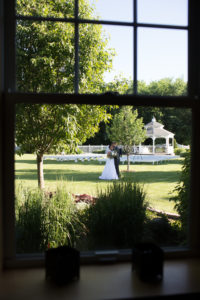 Long view of bride and groom kissing