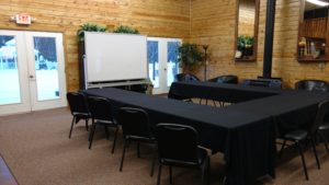 A conference room set up with tables and chairs.