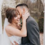 Groom kissing the bride on cheeks