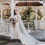 Bride standing holding flower bouquet