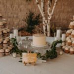 Wedding cake, cupcakes and candles on the table