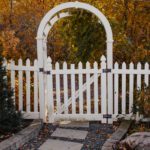 A white picket fence in a garden.