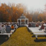 A wedding ceremony with a gazebo in the fall.