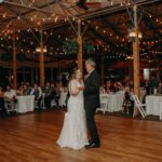 Bride and groom dancing holding their hands