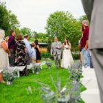 A bride and groom walking down the aisle at an outdoor wedding.