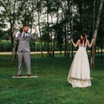 Bride and groom standing on the swing