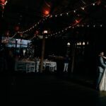 Bride and groom posing in the dark with lights