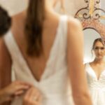 A bride getting ready looking in a mirror