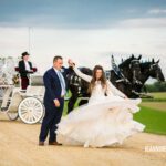 A bride and groom standing next to a horse drawn carriage.