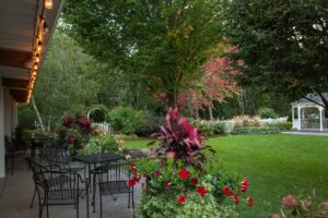 A grassy area with tables and chairs.