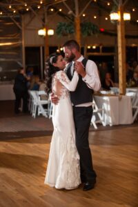 A bride and groom sharing their first dance at their wedding reception.